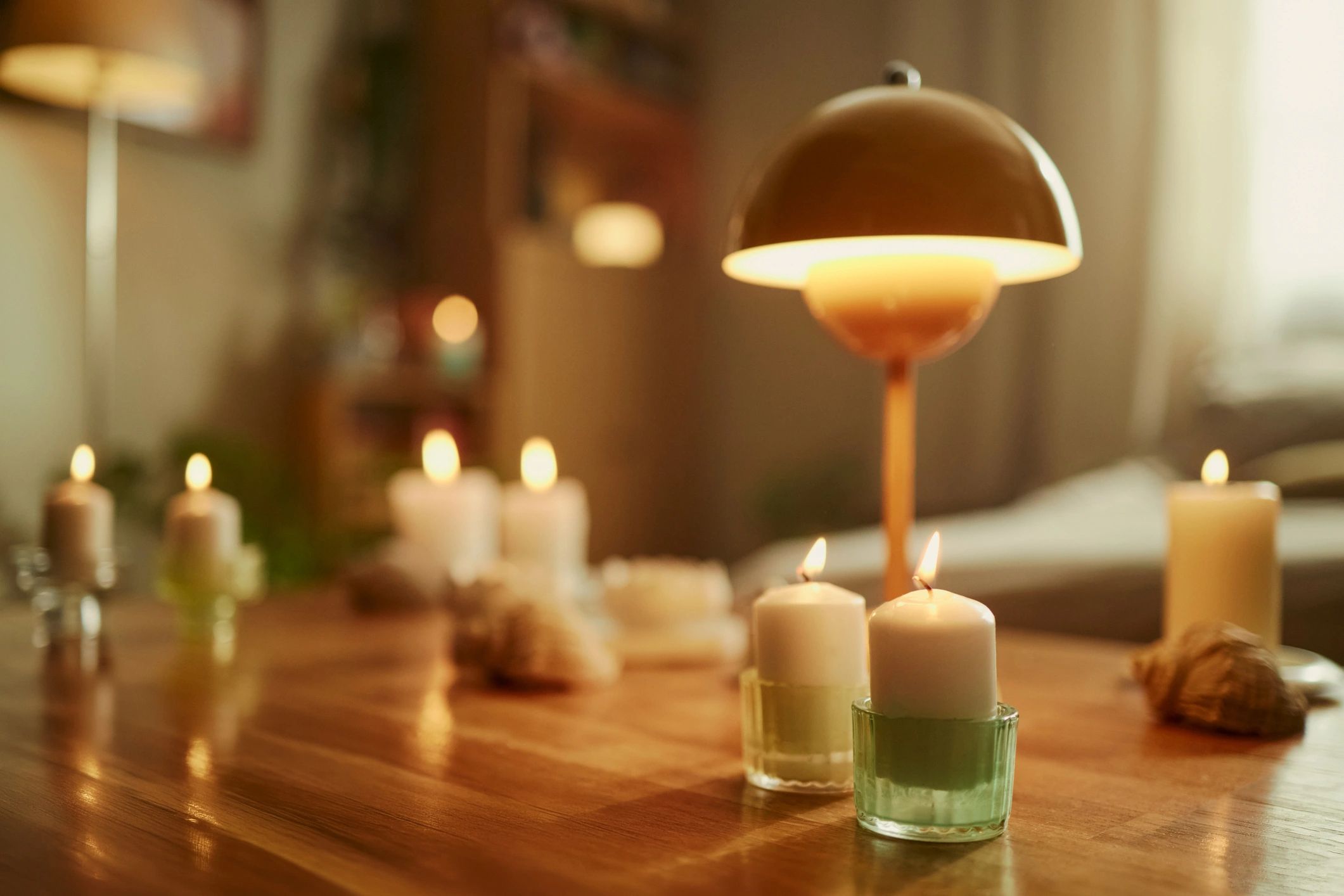 Candles glowing on a table creating a cozy wellness ambience